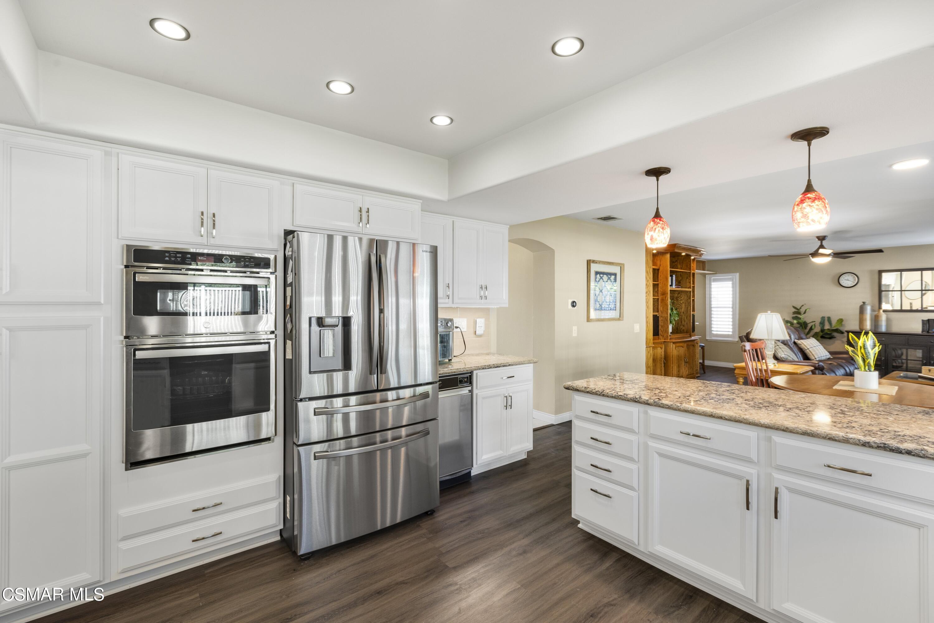 2992 Chippewa Avenue Simi Valley, CA 93063 - Photo 18 of 35 a kitchen with granite countertop stainless steel appliances and wooden floor