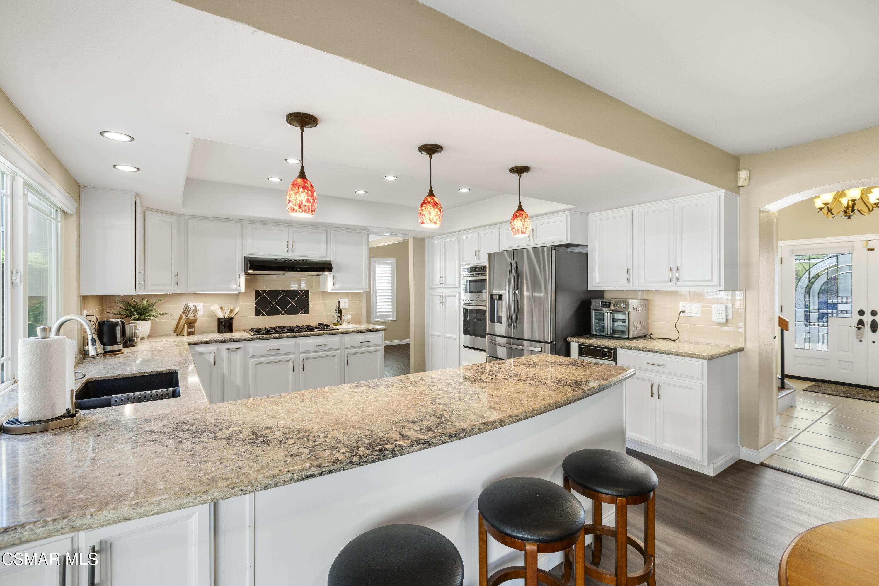 2992 Chippewa Avenue Simi Valley, CA 93063 - Photo 19 of 35 a large kitchen with granite countertop lots of counter space and wooden floor