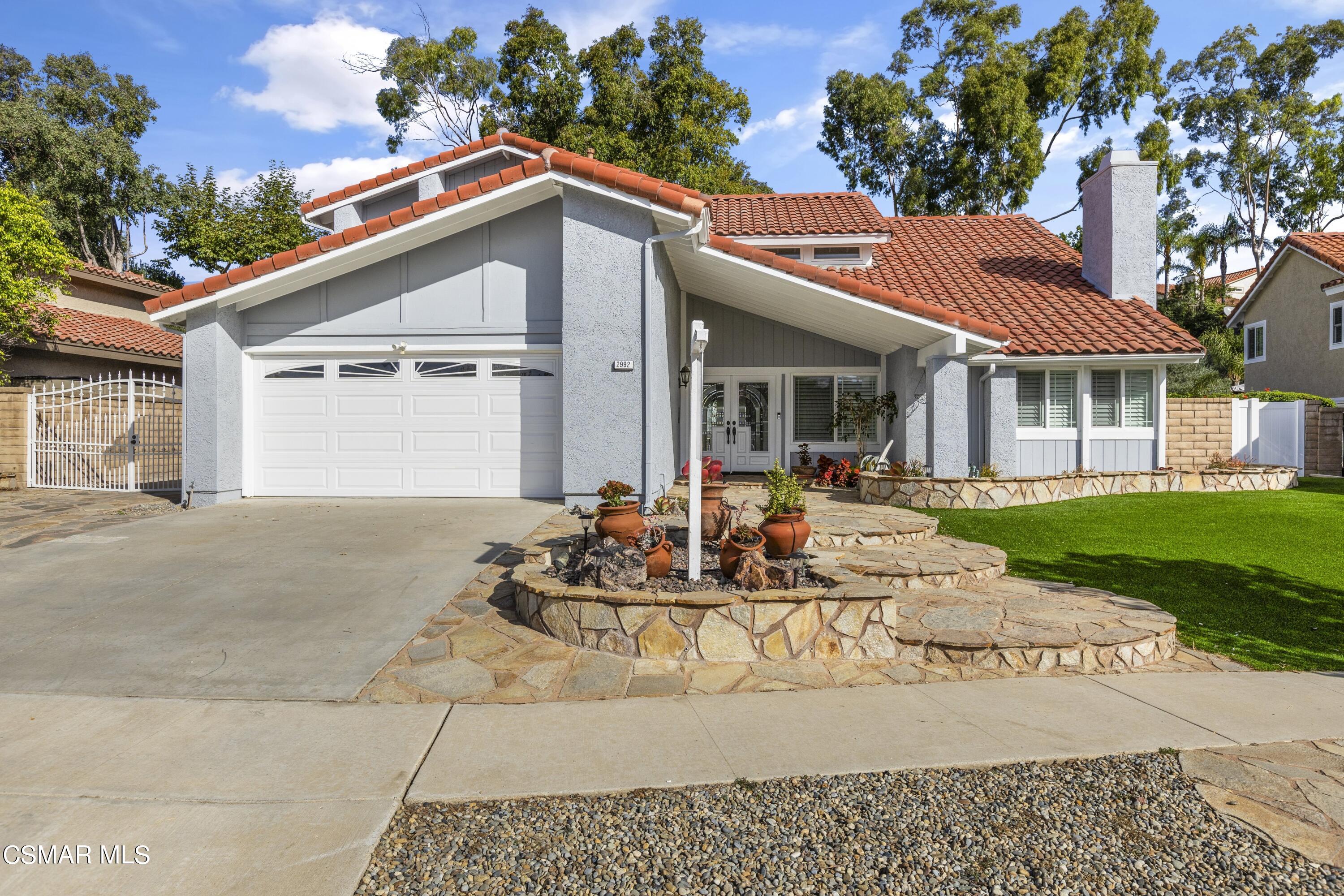 2992 Chippewa Avenue Simi Valley, CA 93063 - Photo 2 of 35 a view of a white house with a fountain in a yard