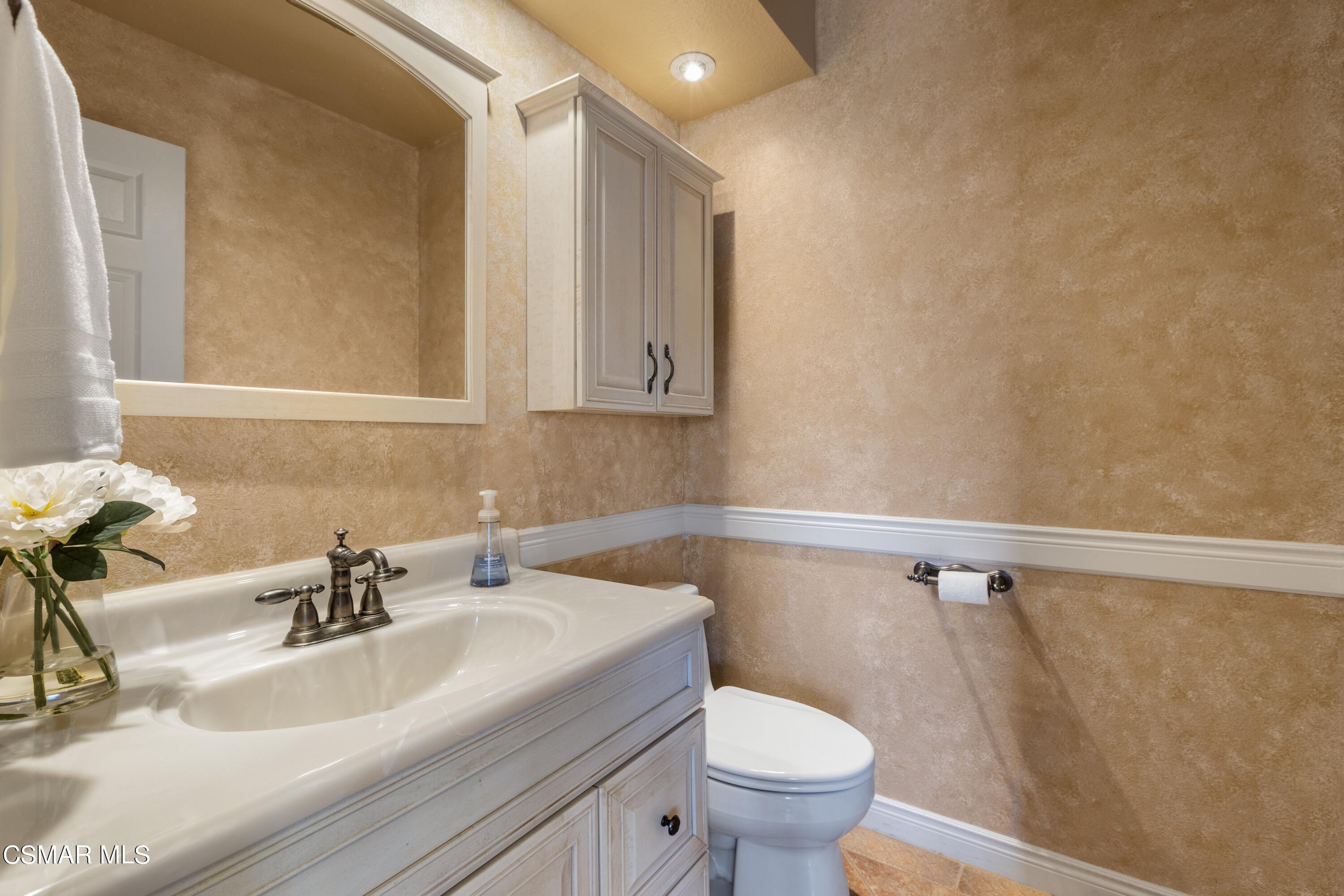 2992 Chippewa Avenue Simi Valley, CA 93063 - Photo 25 of 35 a bathroom with a sink a toilet and a mirror