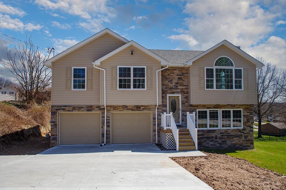1070 Chapel Road Monaca, PA 15061 - Photo 1 of 24 a front view of a house with a yard and garage