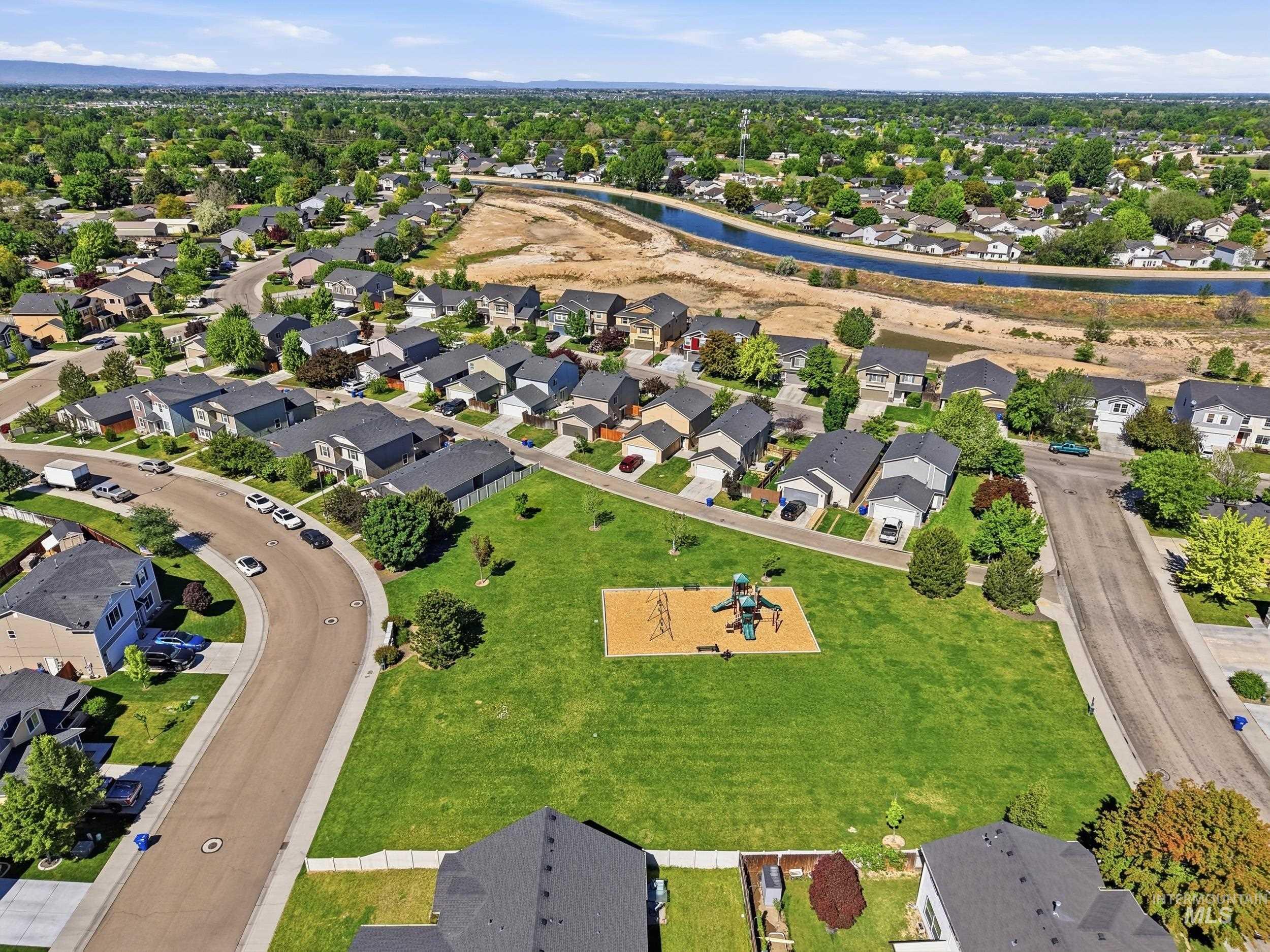 4855 South Chex Way Boise, ID 83709 - Photo 41 of 47 Aerial perspective showcasing a residential neighborhood with a central green space featuring a playground
