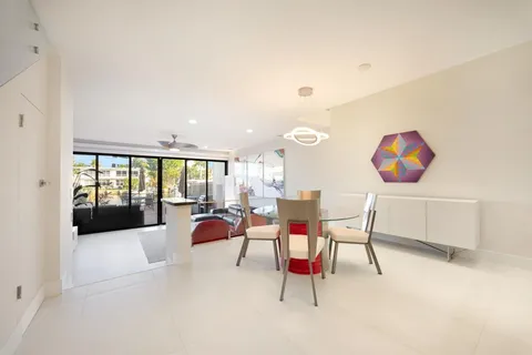 a living room with furniture and floor to ceiling window
