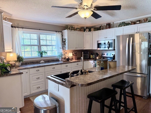 968 St Mathews Church Road Metter, GA 30439 - Photo 3 of 35 a kitchen with stainless steel appliances a sink a stove and a refrigerator