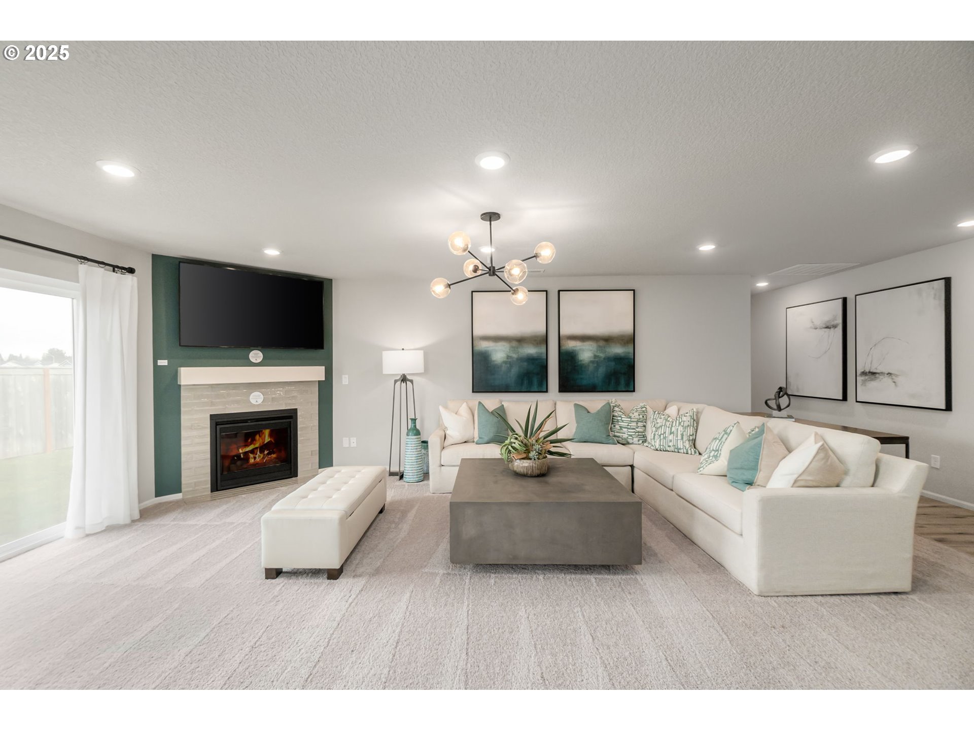 1011 Clemson Street Gervais, OR 97026 - Photo 8 of 16 a living room with furniture a fireplace and a flat screen tv