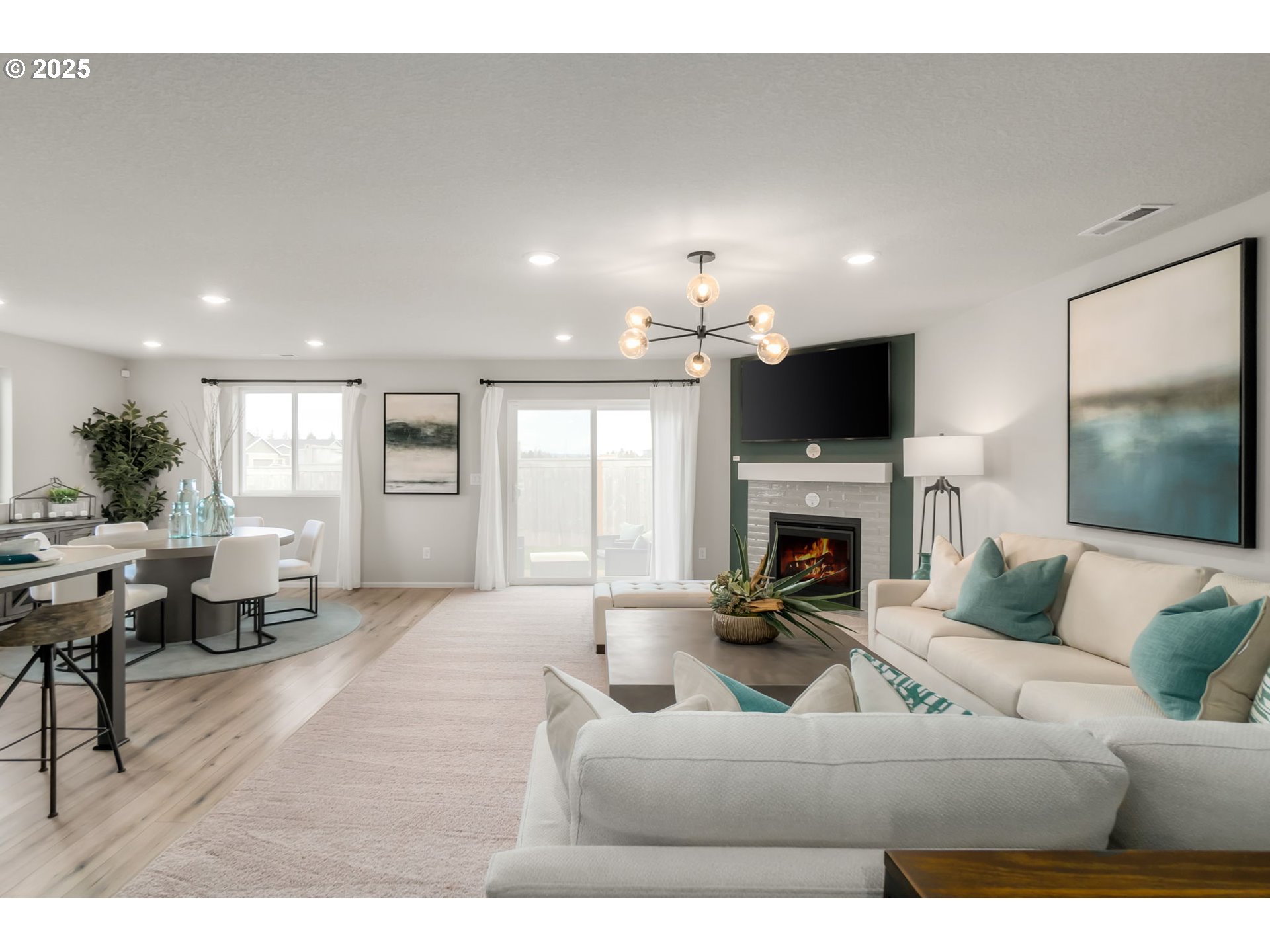 1011 Clemson Street Gervais, OR 97026 - Photo 10 of 16 a living room with furniture a fireplace and a flat screen tv