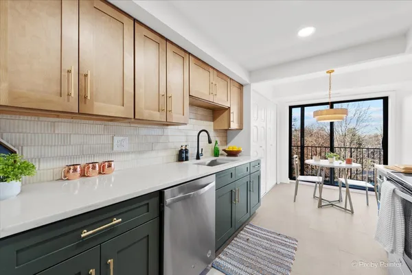 a kitchen with stainless steel appliances granite countertop a sink a stove and cabinets