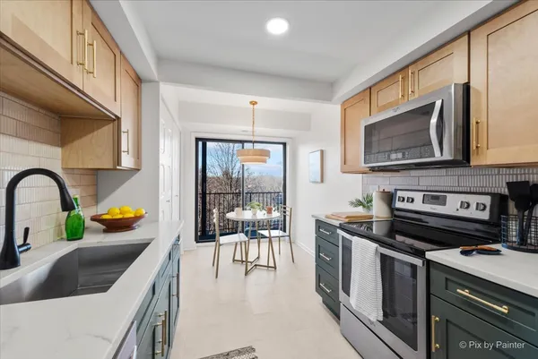 a kitchen with stainless steel appliances a stove a sink a microwave and cabinets