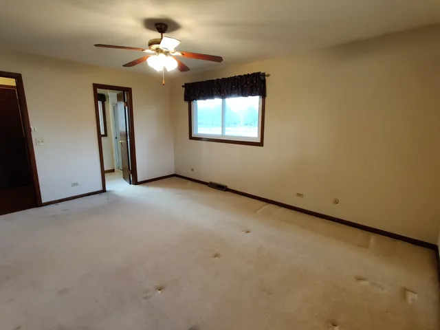 a view of a livingroom with a chandelier fan