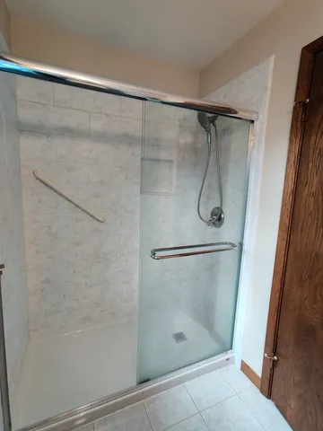 a bathroom with a glass shower door