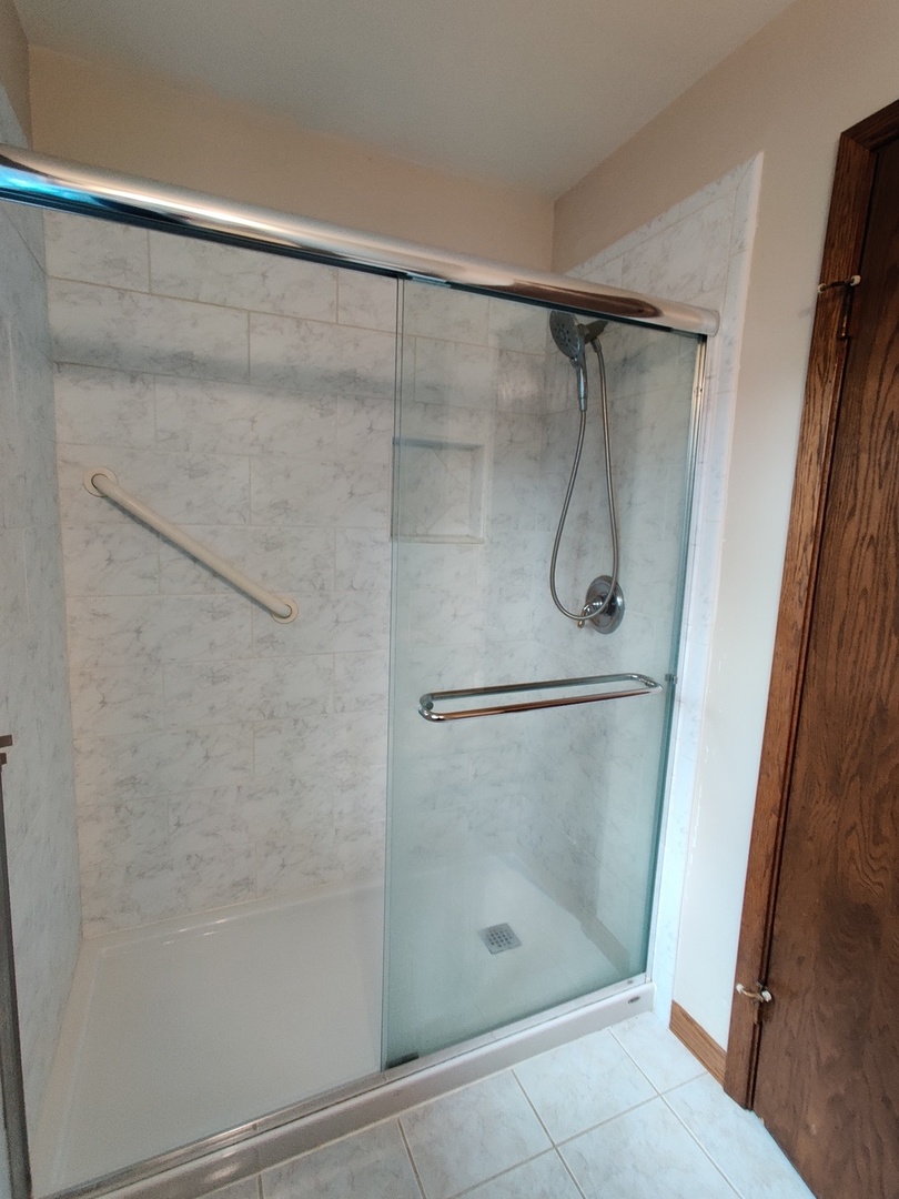 8N601 Stevens Road Elgin, IL 60124 - Photo 17 of 34 a bathroom with a glass shower door