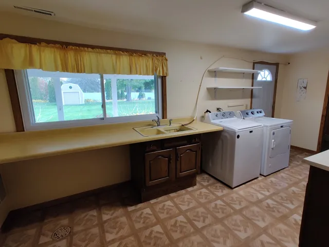 a kitchen with a sink stove and cabinets
