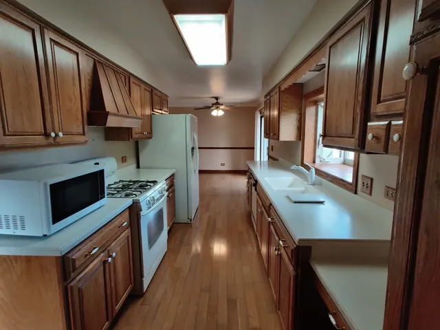 a kitchen with stainless steel appliances granite countertop a stove a sink and a refrigerator