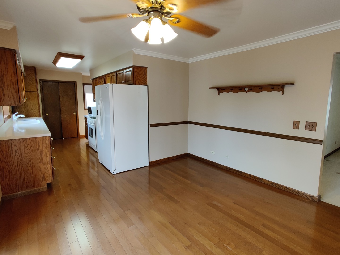 8N601 Stevens Road Elgin, IL 60124 - Photo 6 of 34 a view of an empty room with wooden floor and a window