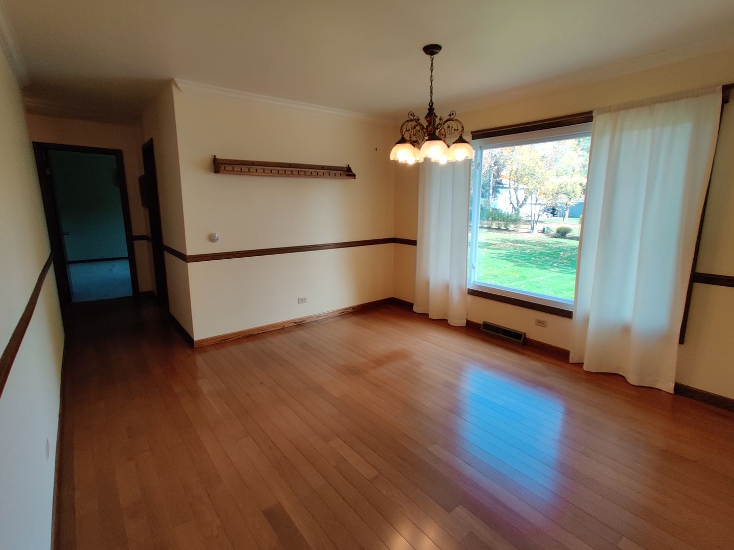 8N601 Stevens Road Elgin, IL 60124 - Photo 8 of 34 a view of a room with wooden floor a ceiling fan and a window