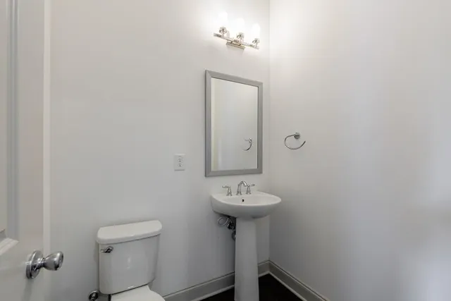 a bathroom with a sink toilet and mirror