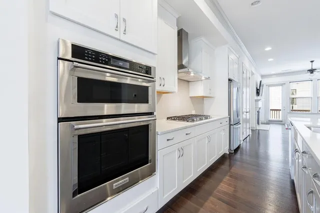 a kitchen with stainless steel appliances white cabinets and a stove