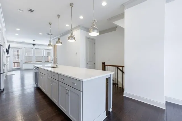 a kitchen with a stove a sink and a refrigerator