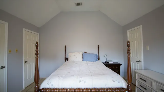 a large white bed in a white room