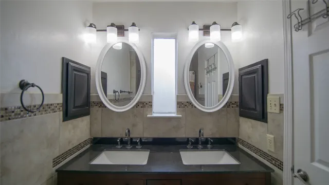 a bathroom with sinks mirror and vanity
