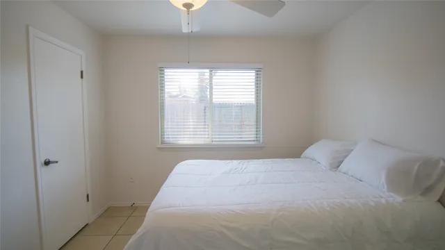 a bedroom with a bed and a window