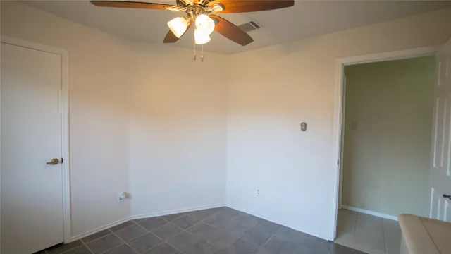 an empty room with a fan