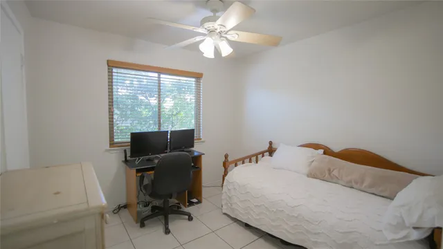 a bedroom with a bed and a desk