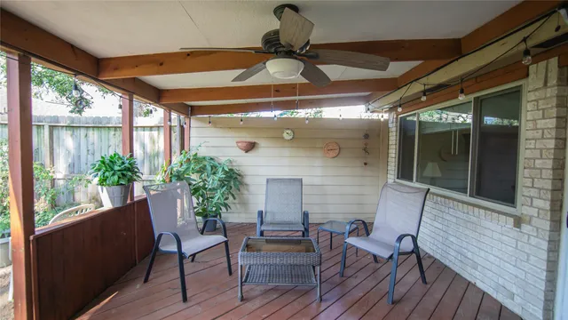 a balcony with furniture and potted plants