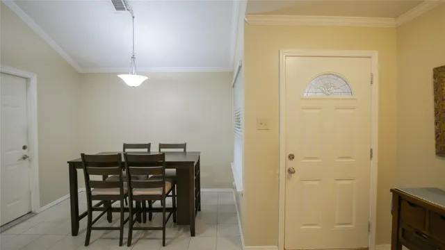 a view of a dining room with furniture and a chandelier