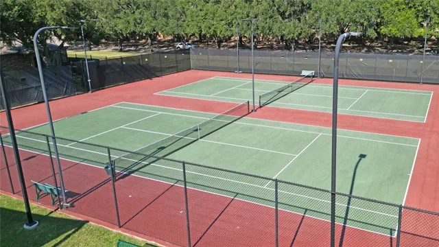 a view of a tennis court with sitting area
