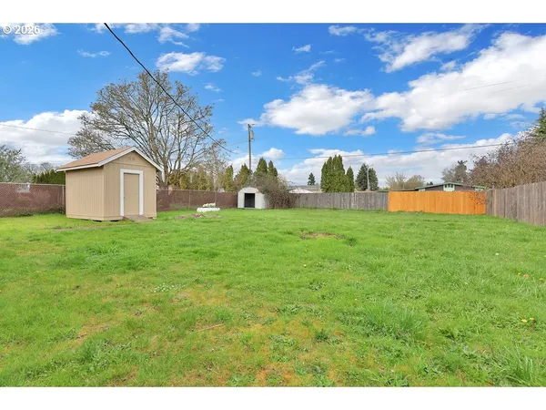 a view of a backyard with small cabin