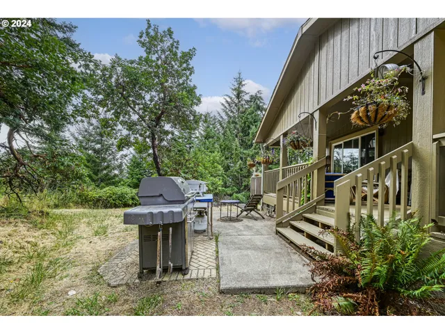 a backyard of a house with table and chairs