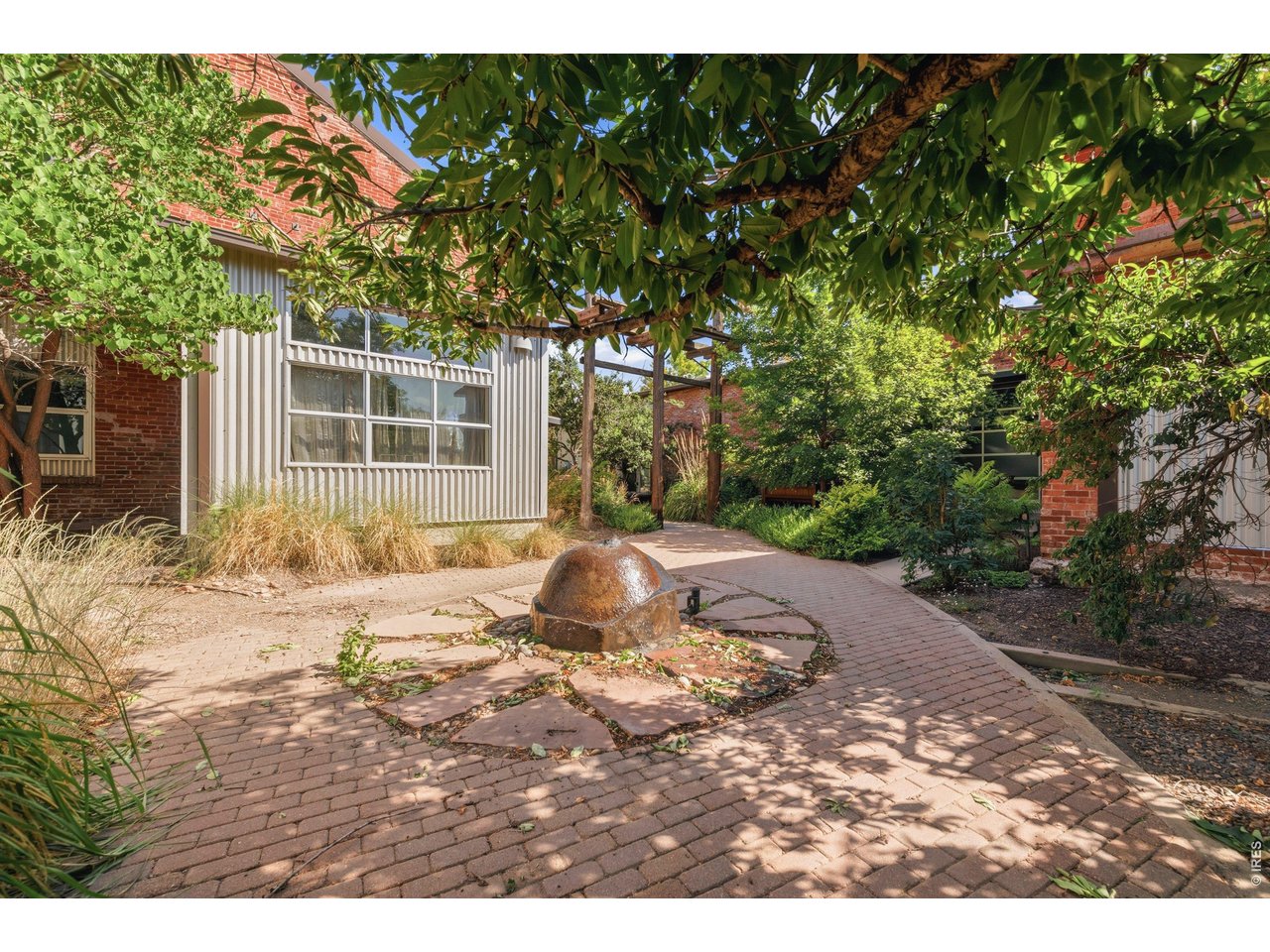 3033 Blake Street, Unit 112 Denver, CO 80205 - Photo 28 of 28 a backyard of a house with yard and outdoor seating