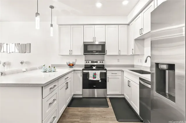 a kitchen with stainless steel appliances a stove sink and cabinets