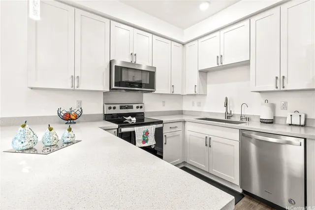 a kitchen with granite countertop white cabinets and white appliances