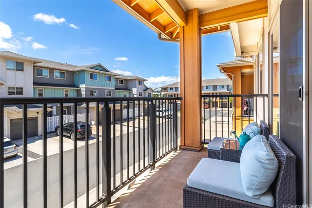 a view of a balcony with chairs and floor to ceiling window