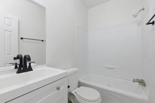 a bathroom with a sink a toilet and bathtub