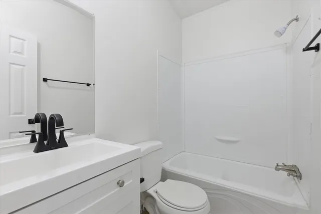 a bathroom with a sink a toilet and bathtub