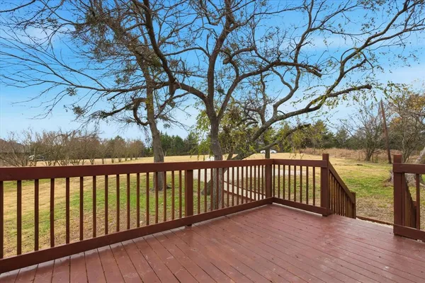 a view of balcony with wooden floor and fence