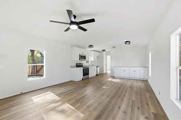 a view of a livingroom with a ceiling fan and window