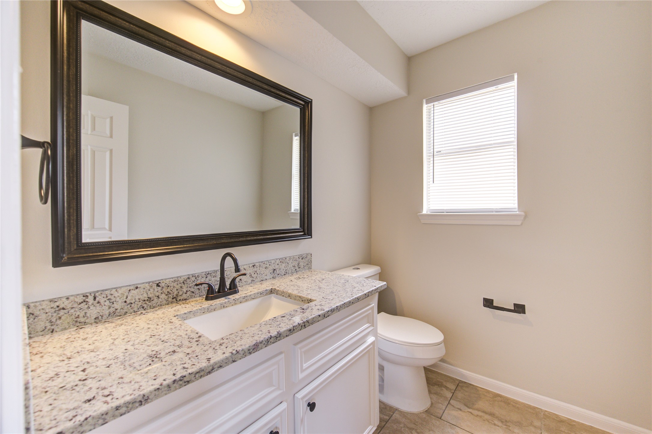 9115 Taidswood Drive Spring, TX 77379 - Photo 32 of 45 There is another half-bath, located near the game room, and it has a granite counters, a modern rectangle sink, with bronze hardware, recessed LED lighting and mirror. This lovely home has 2-half baths (one down and one up) and 2 full-sized baths.