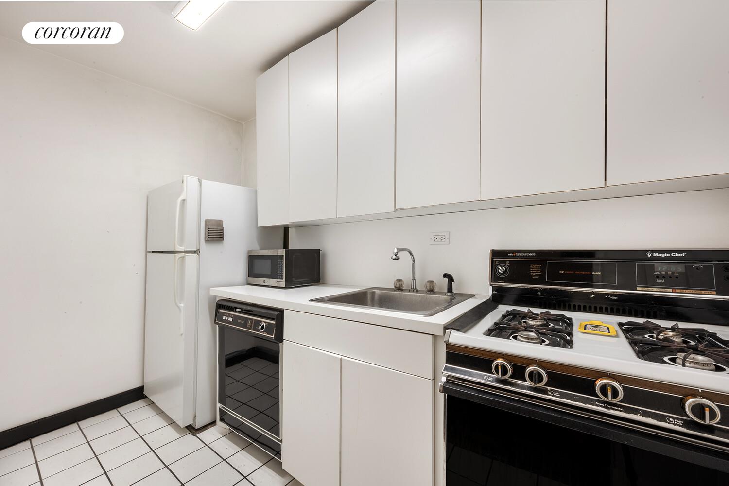 315 East 70th Street, Unit 4D Manhattan, NY 10021 - Photo 4 of 6 a kitchen with a stove and a refrigerator
