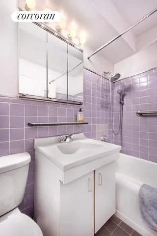 a bathroom with a sink toilet vanity and tub