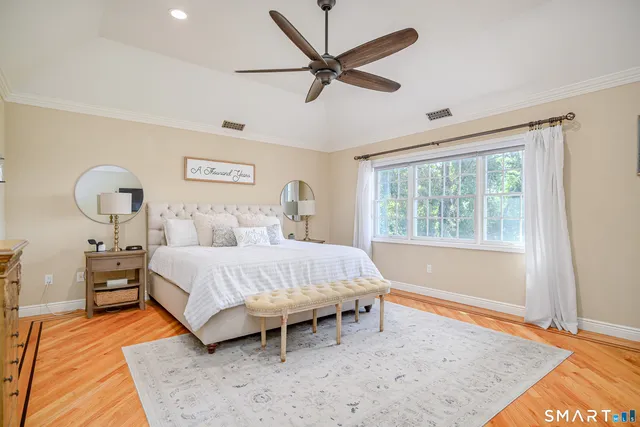 a spacious bedroom with a bed and a table in it