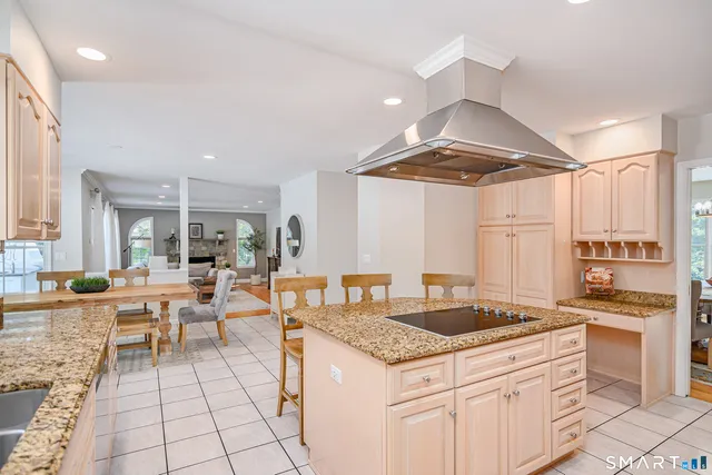 a kitchen with granite countertop a sink stove and cabinets