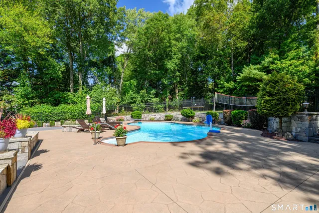 a view of a backyard with swimming pool
