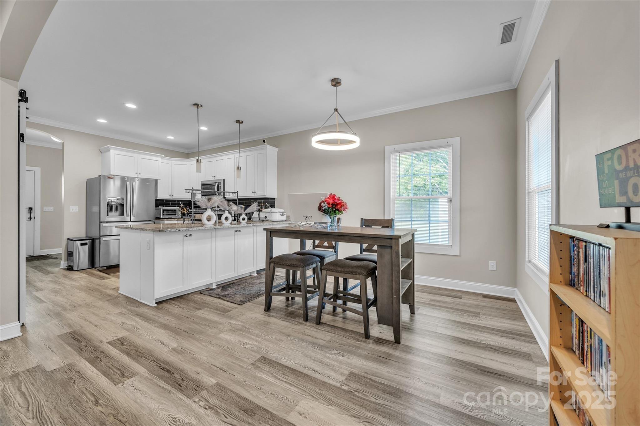 2510 Snow Creek Road Northeast Hickory, NC 28601 - Photo 13 of 45 a kitchen with stainless steel appliances kitchen island granite countertop a table chairs refrigerator and a window