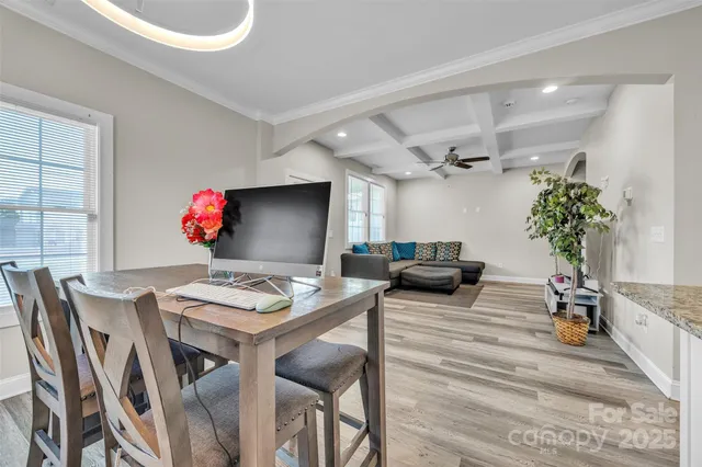 a view of a dining room with furniture and a potted plant