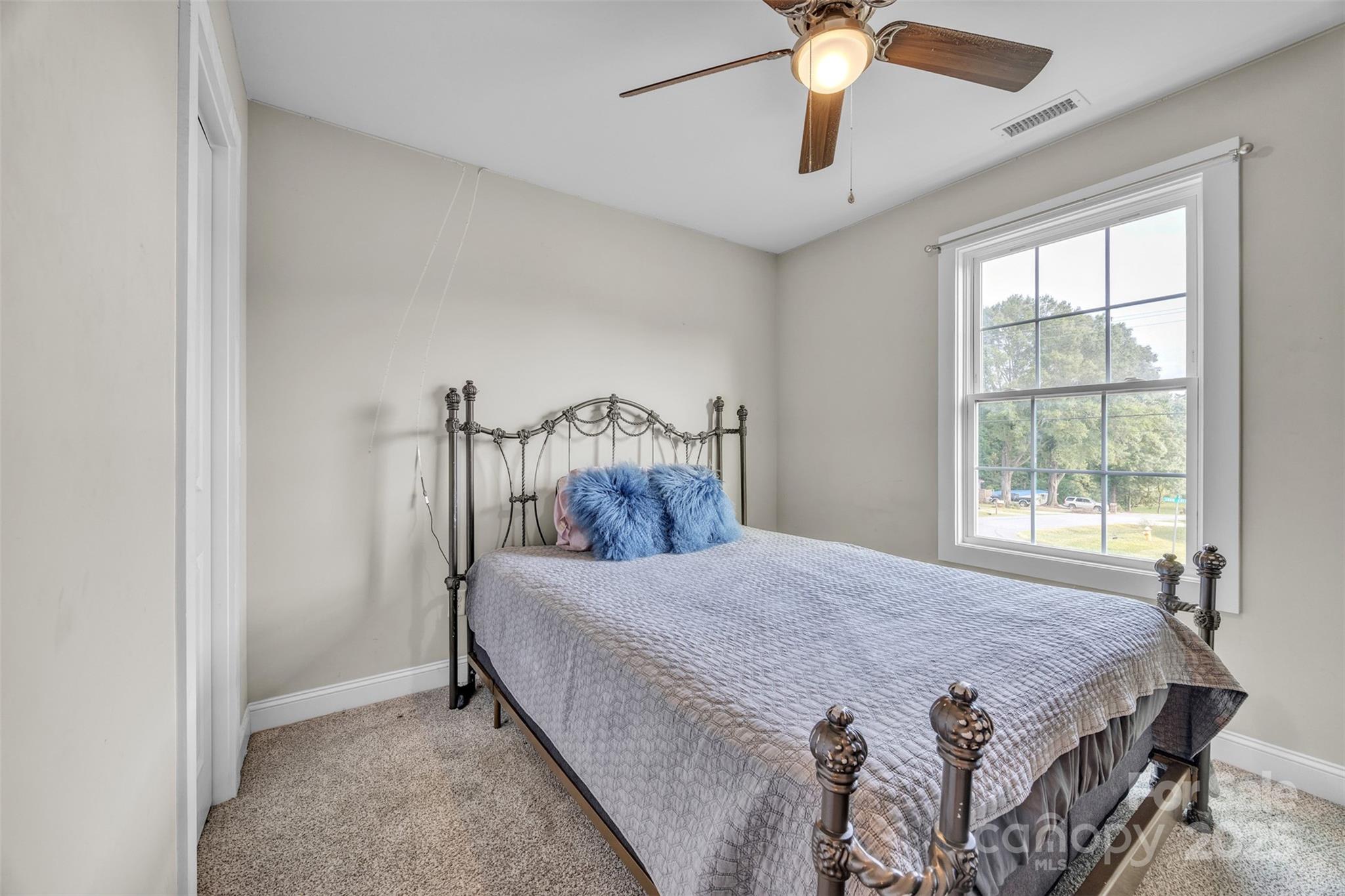 2510 Snow Creek Road Northeast Hickory, NC 28601 - Photo 22 of 45 a bedroom with a bed and a chandelier