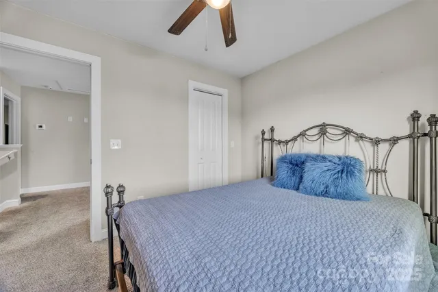 a bedroom with a large bed and a chandelier
